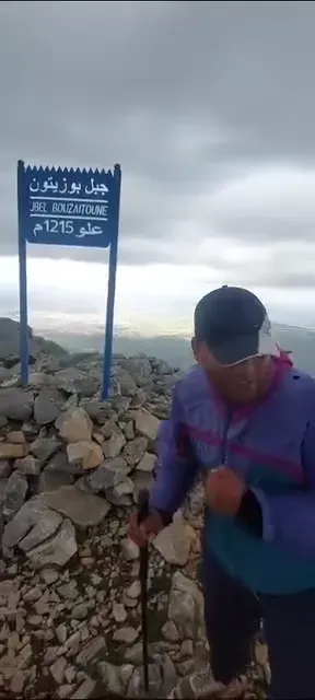 Guide Imad Ben Yahya by the summit sign of Jbel Bouzitoun, above Tetouan